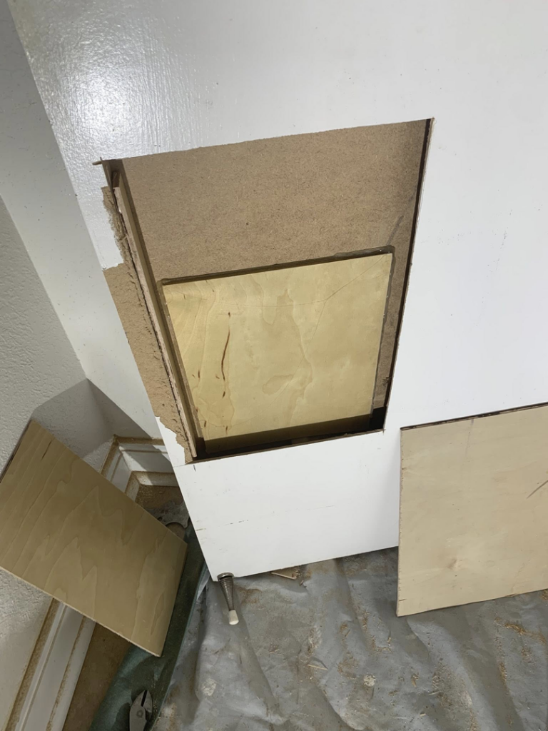 A mounted television above a stone veneer fireplace with a wooden mantel, showcasing installation work by Rock Solid Handyman Services in Sparks, NV.