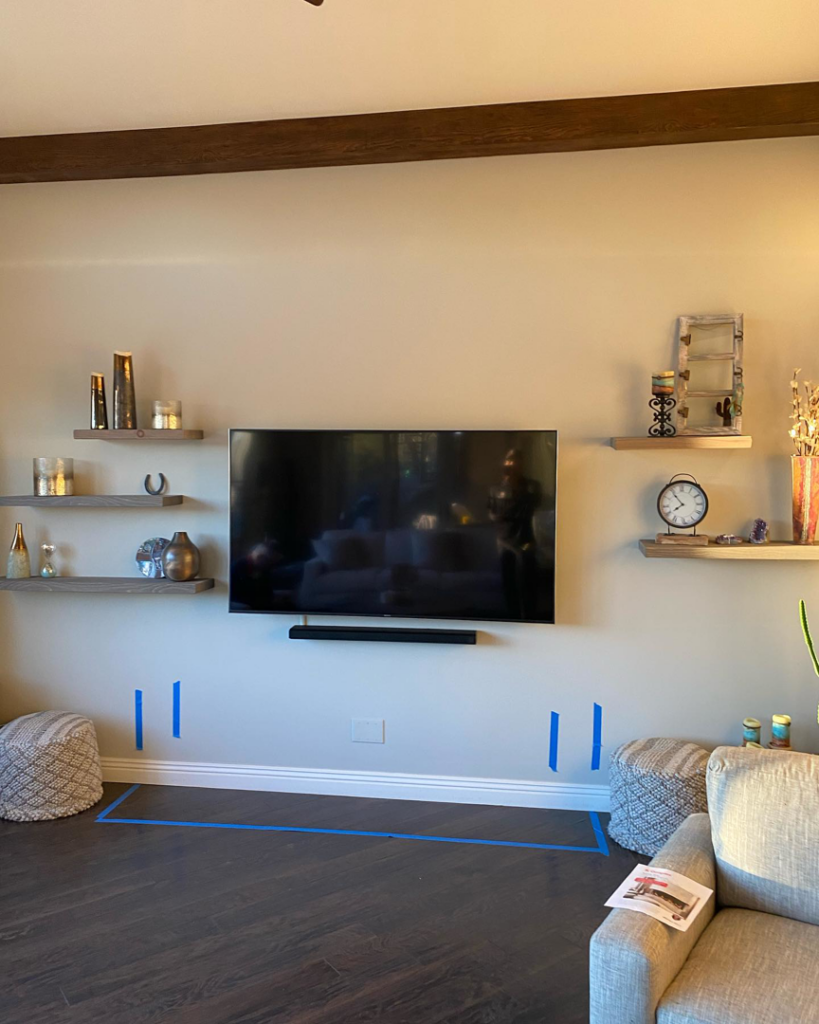 Wall-mounted TV and floating shelves installation, a handyman service by Arizona Prestige Flooring in Surprise, AZ