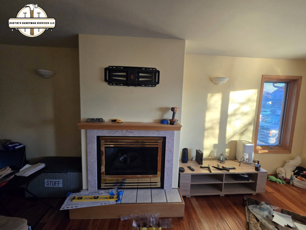 A TV wall mount installed above a fireplace, in progress, by Dustin's Handyman Services LLC in Great Falls, MT.