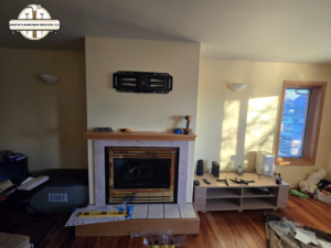 A TV wall mount installed above a fireplace, in progress, by Dustin's Handyman Services LLC in Great Falls, MT.