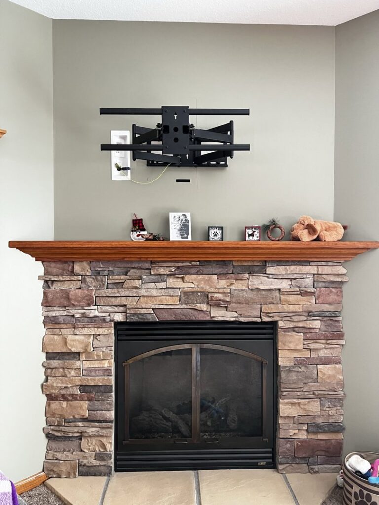 A heavy-duty TV wall mount installed above a fireplace by Med City Handy Ma'am in Rochester, MN