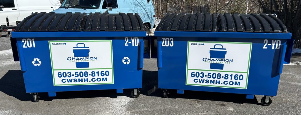 Two blue commercial dumpsters provided by Champion Waste Services for businesses in Londonderry, NH.