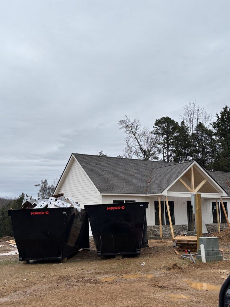 Two dumpsters at a construction site for debris removal by Mobile Dumpster Solutions in Chattanooga, TN.