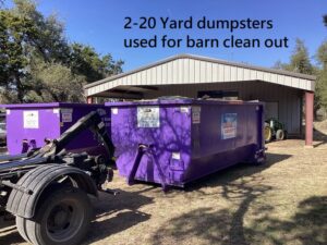 Two 20-yard purple dumpsters used for a barn clean out by Liberty Hill Dumpster Rental in Austin, TX