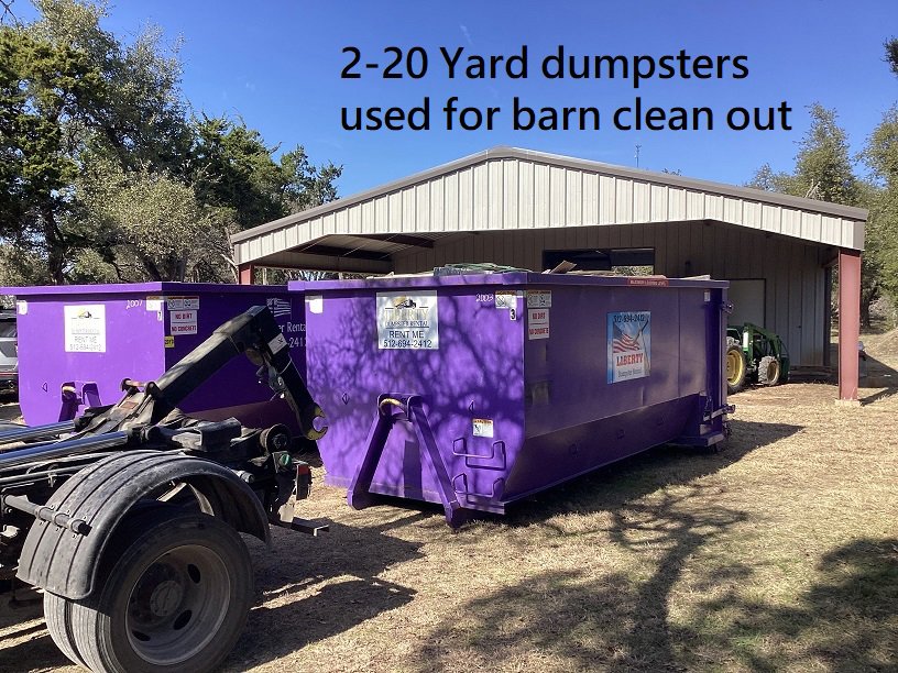 Two 20-yard purple dumpsters used for a barn clean out by Liberty Hill Dumpster Rental in Austin, TX