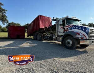Two red dumpsters being delivered or picked up by Trash Daddy in Fort Worth, TX