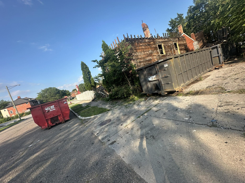 Two dumpsters from The Dump Town on a demolition site, ready for junk removal in Detroit, MI.