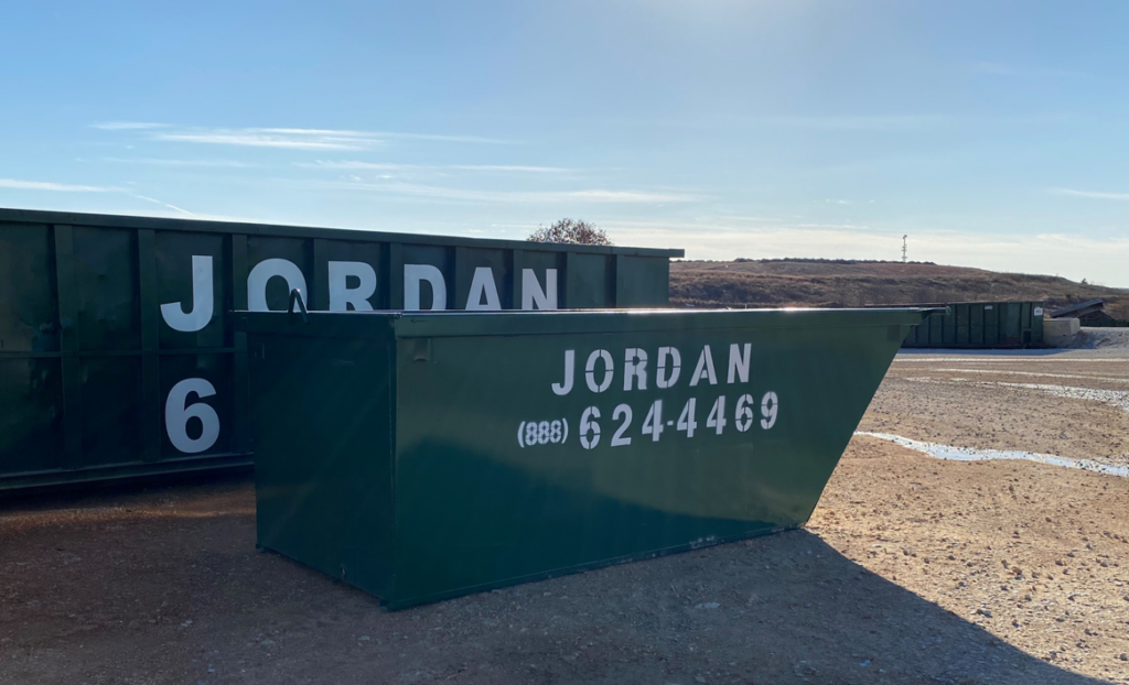 Two green dumpsters, one large and one small, branded 'JORDAN' from Jordan Disposal, LLC in Galena, KS, for waste disposal.