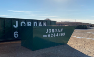 Two green dumpsters, one large and one small, branded 'JORDAN' from Jordan Disposal, LLC in Galena, KS, for waste disposal.