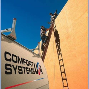 Two handymen from Comfort Systems USA Indiana on ladders performing exterior building repair in Indianapolis, IN.