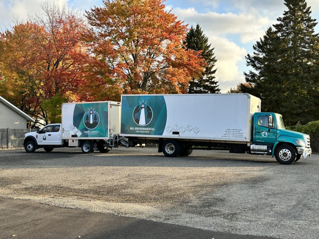Two MLi Environmental trucks parked, prepared for hazardous waste and junk removal jobs in South Portland, ME.
