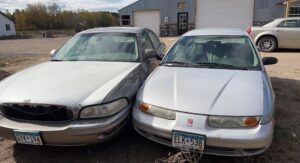 Two old scrap vehicles ready for removal and cash by Cash For Scrap Vehicles / Junk Removal in Minneapolis, MN.
