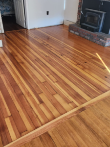 A living area showcasing unique two-tone hardwood flooring, expertly installed by floorzone.inc in Los Angeles, CA.