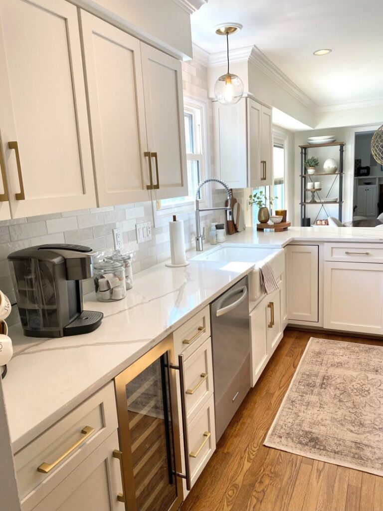A kitchen featuring two-tone cabinets with white uppers and gray lowers, showcasing a refacing project by Cincinnati Cabinet Refacing in Cincinnati, OH.
