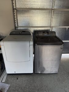 Two washing machines in a garage, ready for appliance removal service by Kern County Junk Removal in Bakersfield, CA.