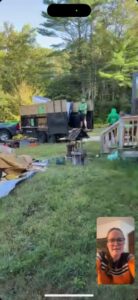 Two workers actively loading various items and debris into the back of a junk removal truck for Trash King LLC in Peoria, AZ.