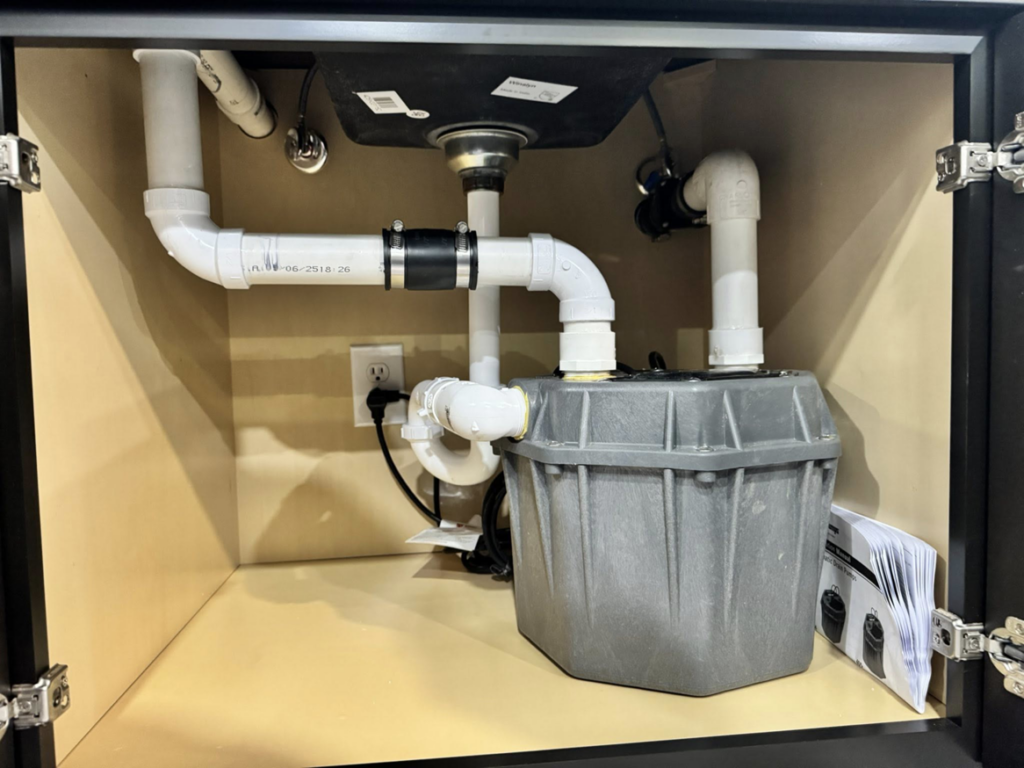 Detailed under-sink plumbing and sump pump installation by Landsaw Craftsman & Co. in Richmond, KY.
