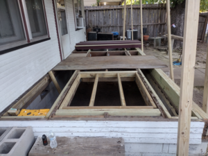 The underlying structure of a porch deck during repair or construction by Do-N-All Handyman Service in Wichita, KS.