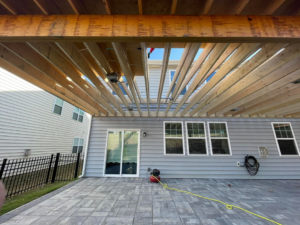 The underside framing of a partially constructed wooden patio cover by A.G Deck & Painting in Charlotte, NC.