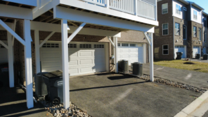 The sturdy underside structure of a newly constructed white deck by Pilgrim Decks and Fence LLC in Elkridge, MD.