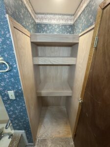 An unfinished built-in shelving unit in a bathroom, showcasing custom carpentry by Northeast SD Handyman in Watertown, SD.