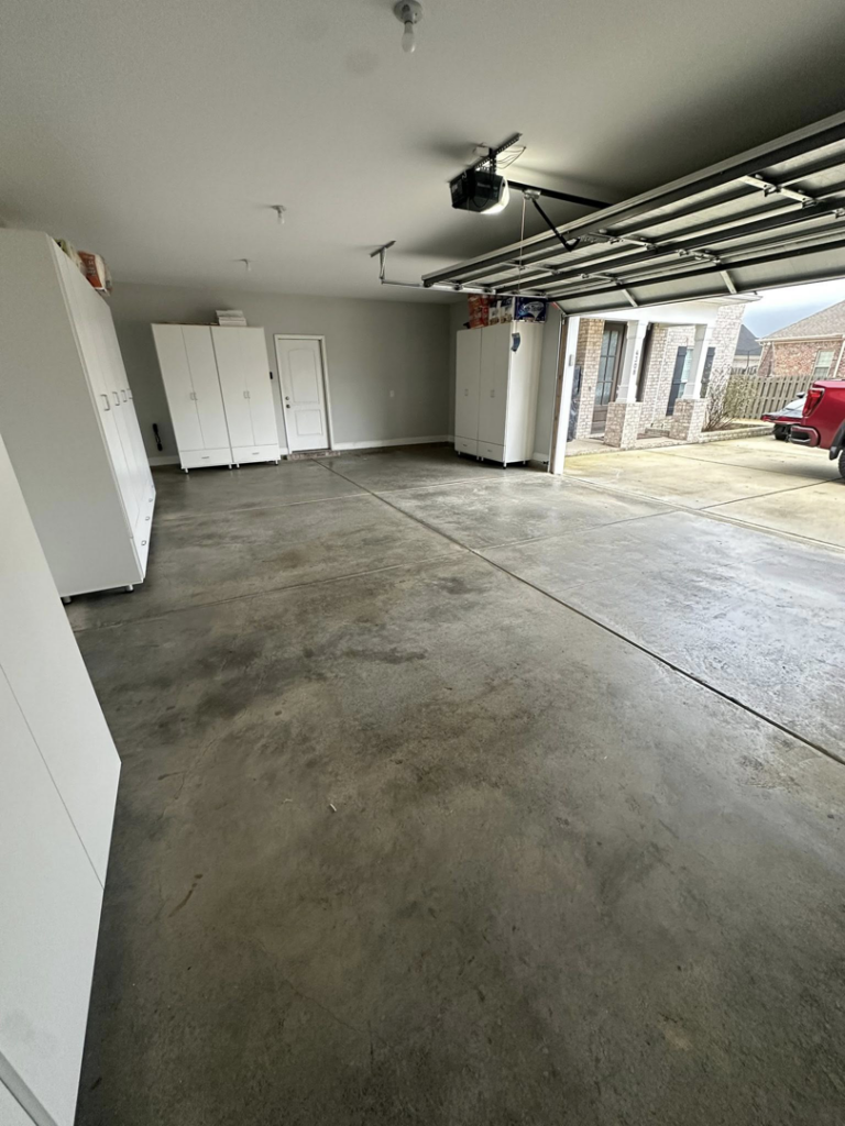An unfinished concrete garage floor before epoxy application by Galaxy Epoxy in Madison, AL.