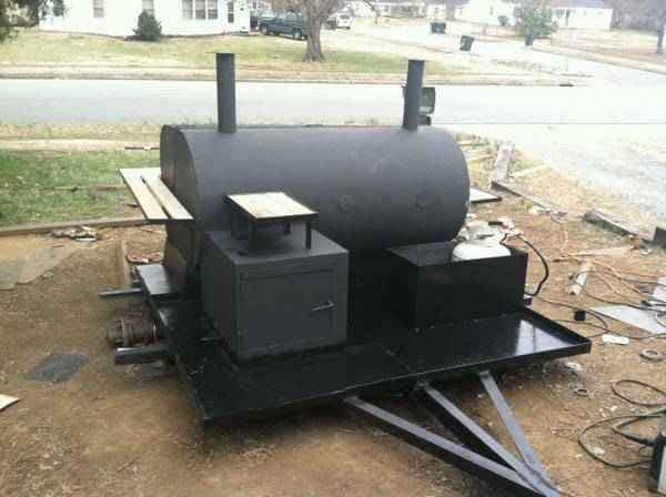 An unfinished custom-built black BBQ smoker on a trailer, fabricated by Charlotte's Welding Service in Rock Hill, SC