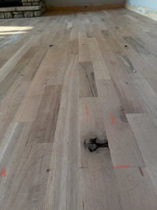 A wider view of an unfinished hardwood floor during installation by Cordell Hardwood Flooring in a home in Lexington, KY.