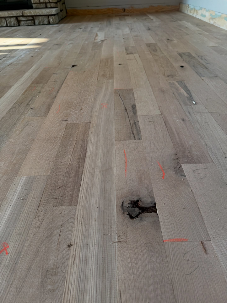 A wider view of an unfinished hardwood floor during installation by Cordell Hardwood Flooring in a home in Lexington, KY.