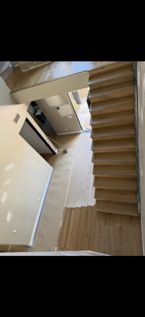 Unfinished hardwood stairs and flooring installation in progress by Arizona Prestige Flooring in Surprise, AZ