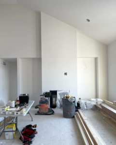 An unfinished room with construction materials and tools, ready for handyman finishing work by Range Custom Homes in Rochester, MN.