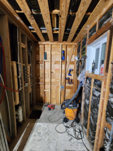 An unfinished room undergoing renovation with exposed plumbing and electrical work by AJAC Restore&Construct LLC in Houma, LA.