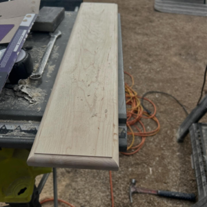 Unfinished wood trim on a workbench with tools, ready for carpentry work by TS ELDER LLC in Phoenix, AZ