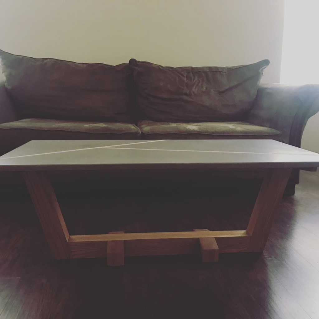 A unique custom-built coffee table with a wooden base and light top by VanArt Designs in Nashville, TN