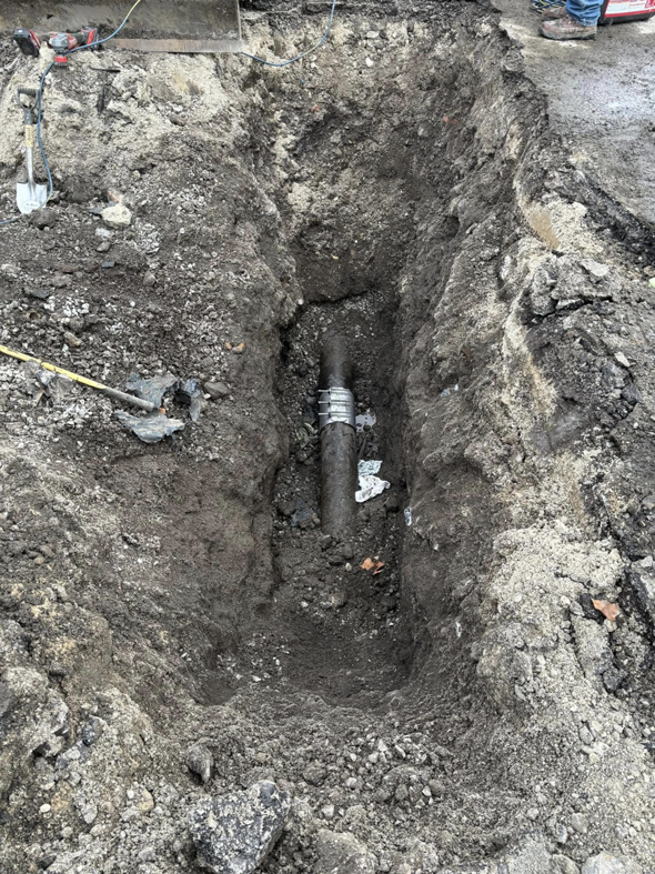 A trench dug for utility pipe repair or installation, showing excavation work by Horhut Inc. in Pittsburgh, PA.