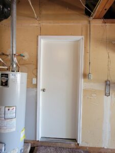Utility room door installation next to a water heater by Max Maintenance in Twin Falls, ID.