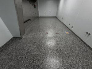 A utility room or corridor with a durable grey speckled epoxy floor coating installed by 812 Concrete Coatings in Evansville, IN.