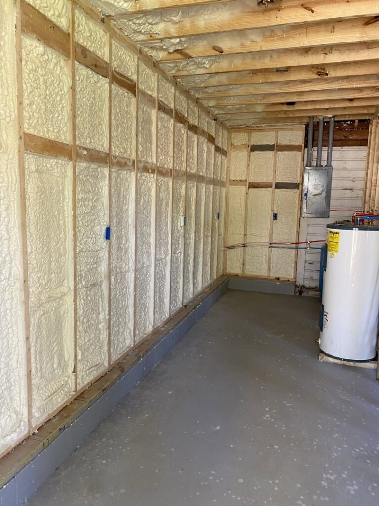 Utility room with spray foam insulation on the walls, showcasing work by Spray Foam Solutions Of Erie in Erie, PA.