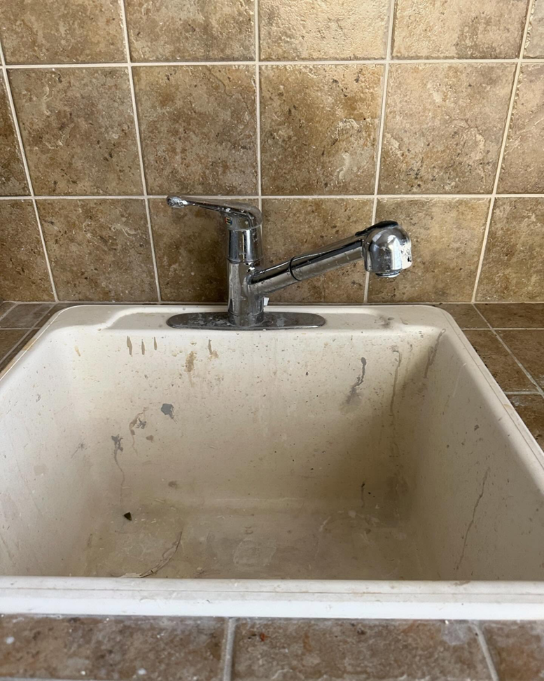 A utility sink and faucet in need of repair or replacement by Syd's Handyman Services in Oxnard, CA.