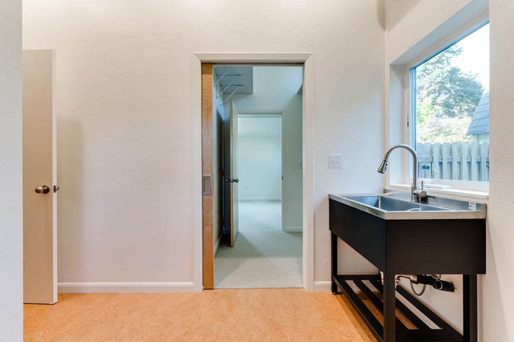 A new utility sink with visible plumbing installed in a laundry room by Matt Bennett Construction in Junction City, OR