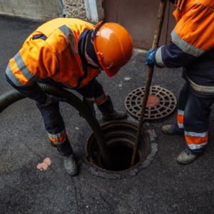 Two utility workers performing manhole cleaning and inspection services for Utility Inspection Services, Inc. in Knoxville, TN.