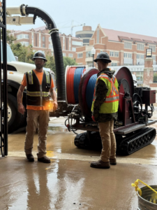 Two utility workers with heavy equipment for inspection and maintenance at Utility Inspection Services, Inc. in Knoxville, TN.