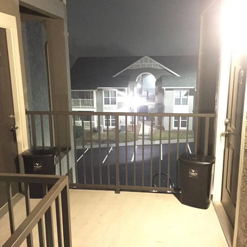 Two valet trash bins on an apartment balcony at night, provided by A1 Valet Trash in Atlanta, GA.