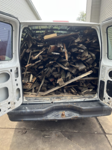 A white van filled with wood debris and junk, ready for removal by Sunny's Junk Removal in Rochester, MN