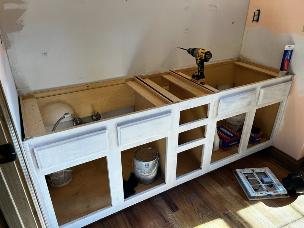 Vanity cabinet installation and painting in progress for a bathroom renovation by Fine Line Painting and Design in Georgetown, KY.