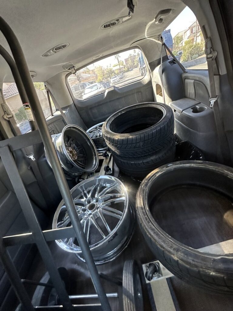 The interior of a vehicle loaded with old tires and rims, ready for transport by MGM Junk Removal in Las Vegas, NV