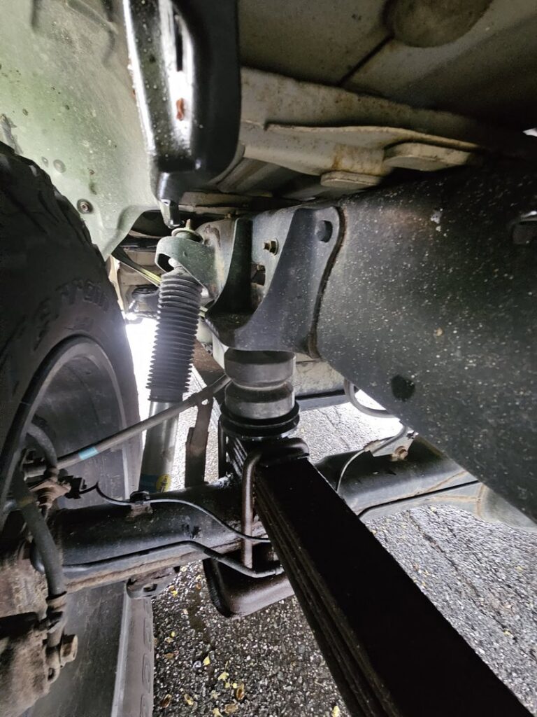 Close-up view of vehicle suspension components, representing heavy-duty outfitting services from Handyman Vehicle Outfitters in Portland, ME.