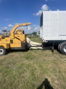 A Vermeer wood chipper attached to a dump truck, ready for tree debris removal by A. Matt Tree Service in Fort Worth, TX.