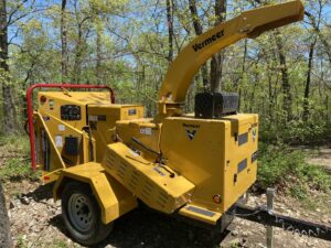 A large yellow Vermeer wood chipper, essential equipment for tree service, used by Affordable Treefellers in Shawnee, KS.