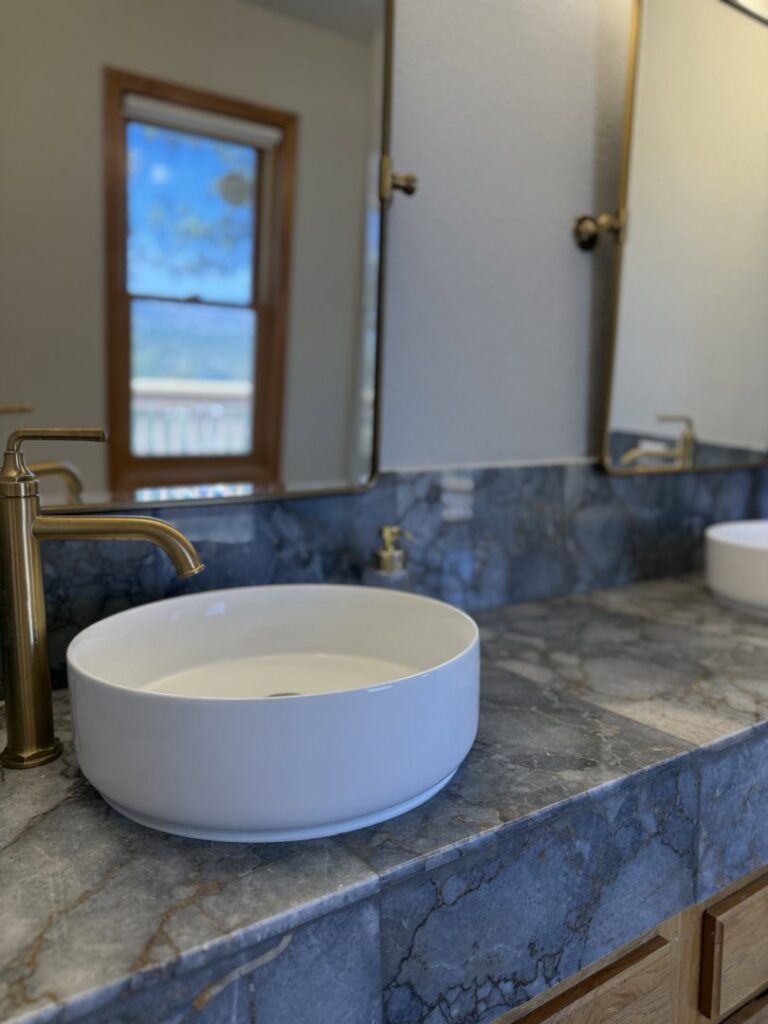 A newly installed vessel sink and gold faucet on a marble countertop by AZ New Bath in Glendale, AZ